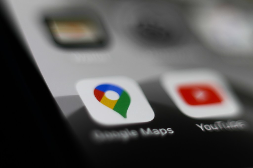 Google Maps logo is seen displayed on smartphone