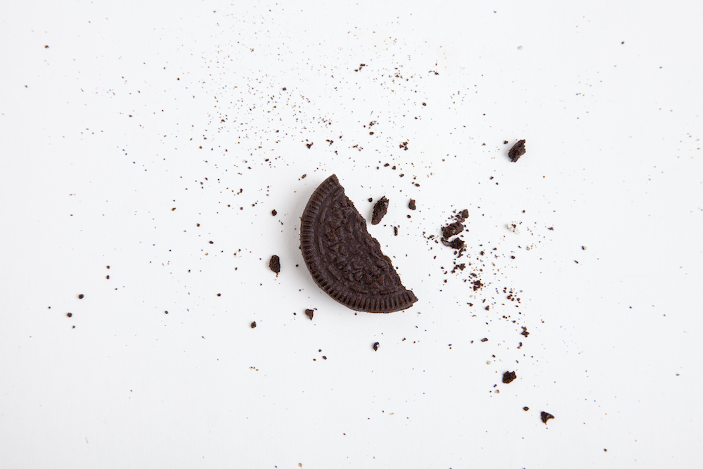 Chocolate sandwich cookie. Half a broken cookie