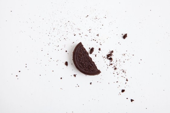 Chocolate sandwich cookie. Half a broken cookie