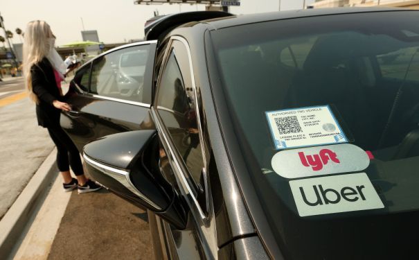Woman entering an Uber/Lyft car
