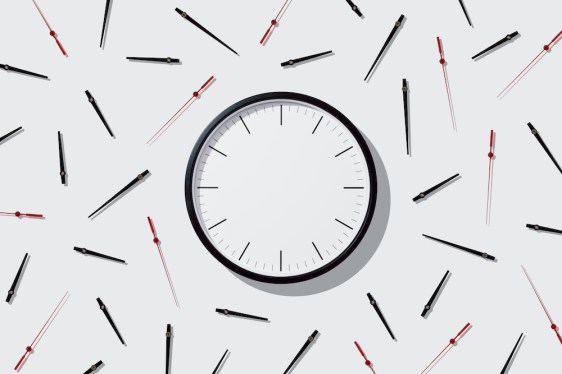 Blank Clock Face with Separated Hands on Solid Beige Colored Background Directly Above View.