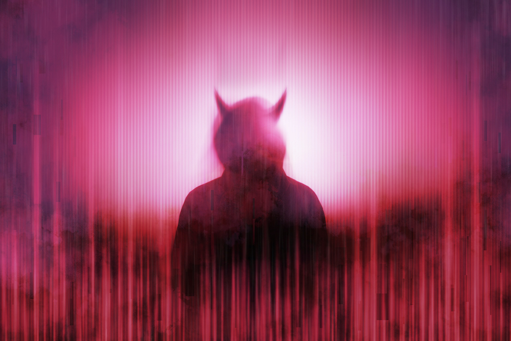 Silhouette of a mysterious horned devil figure without a face, surrounded by a glitch, red, neon edit.