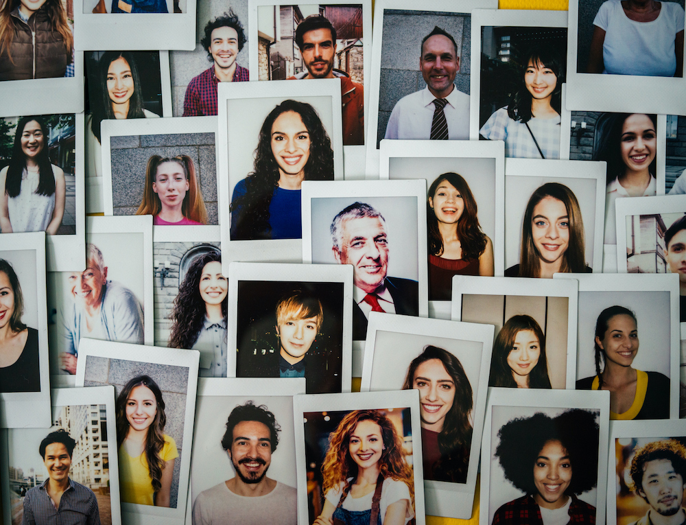 Polaroid photos of different people hanged on the wall.
