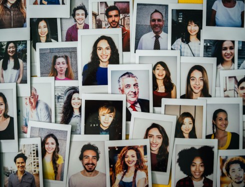 Polaroid photos of different people hanged on the wall.