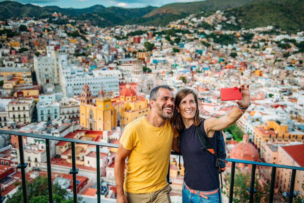 Couple visiting Guanajuato from lookout on the mountain. Mexico