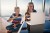 Brother and sister sitting modern apartment and learning sign language online.