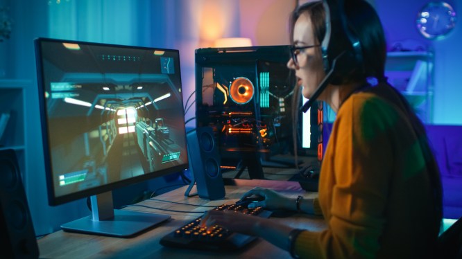 woman sitting at desktop, gaming