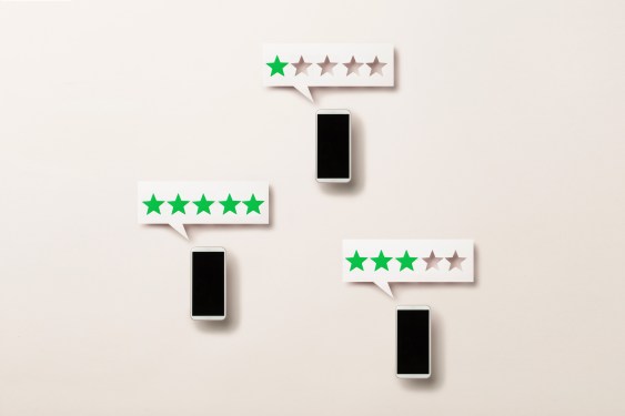 Wooden five star shape with Chat Bubble and smart phone.