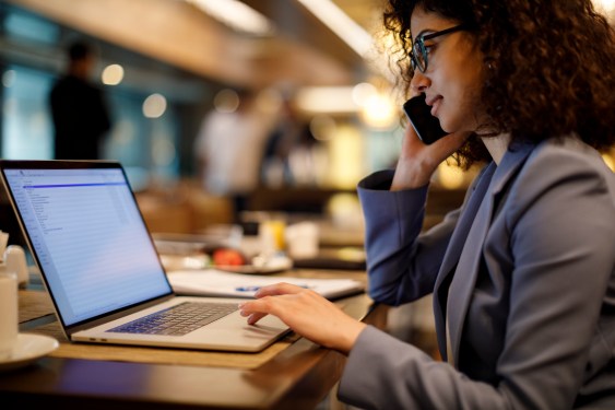 Businesswoman working on laptop in restaurant