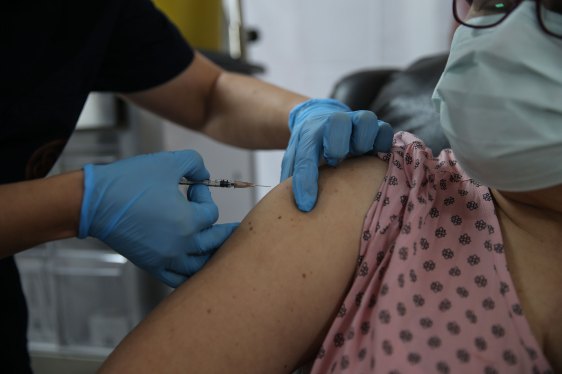A health care worker injects the a syringe of the phase 3 vaccine trial, to a volunteer at the Ankara University Ibni Sina Hospital in Ankara, Turkey