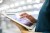 Cropped image of businesswoman using digital tablet in office