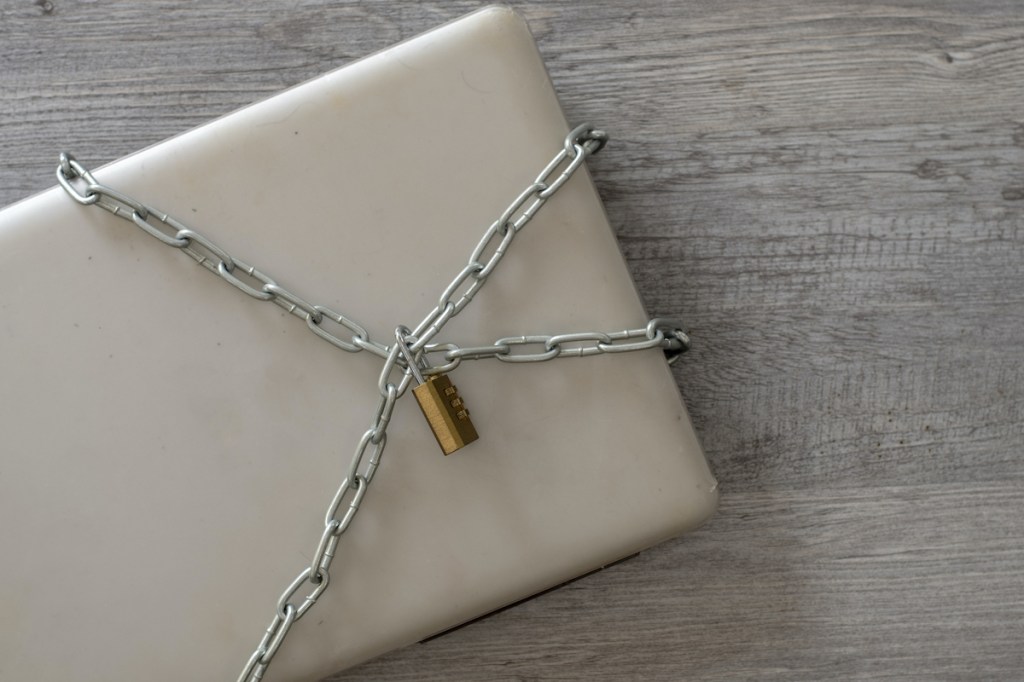 A laptop chained and padlocked in an attempt to keep it safe.