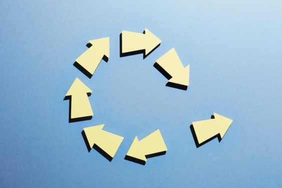 A group of arrows moving in a circle with one arrow breaking away