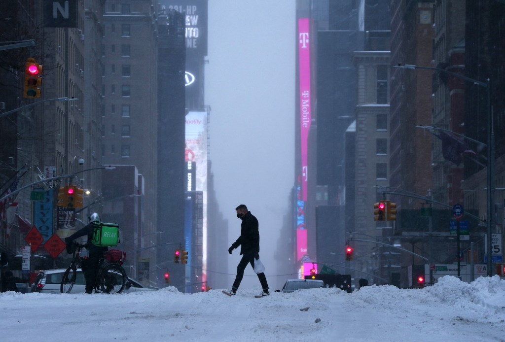 NEW YORK, NY - DECEMBER 17: A man walks across 7th Avenue during a snowstorm on December 17, 2020 in New York City. (Photo by Gary Hershorn/Getty Images)