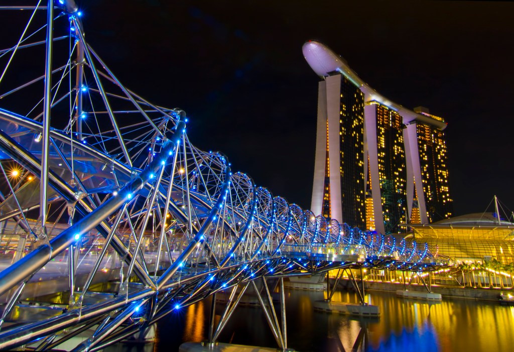 An evening view of Helix Bridge and Marina Bay Sands in Singapore