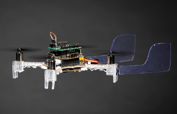 Image of a small drone in flight with a moth antenna attached to the front.