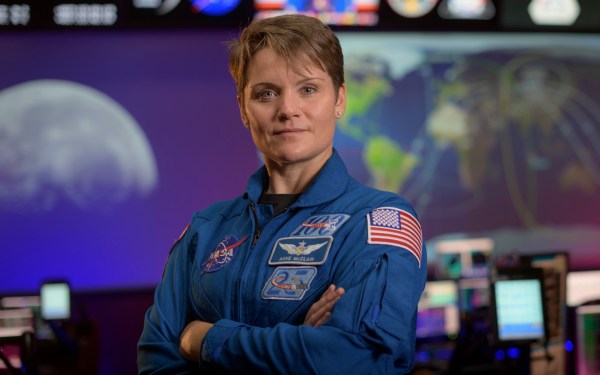 NASA astronaut Anne McClain poses in micsion control.