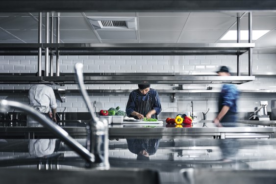 A photo from cloud kitchen startup JustKitchen, showing cooks prepping meals for delivery