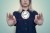 Woman's hands hold a wall clock balanced on a thread