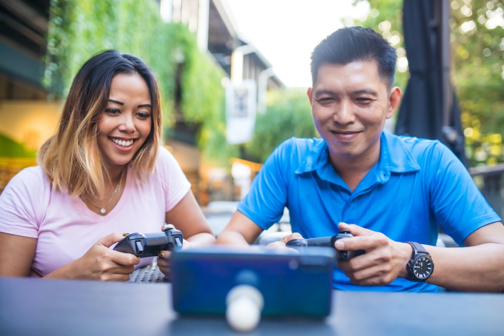 Thai people using technology in their everyday lives. Playing game.