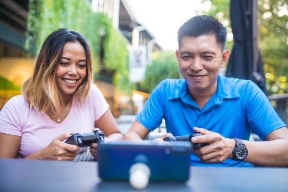 Thai people using technology in their everyday lives. Playing game.