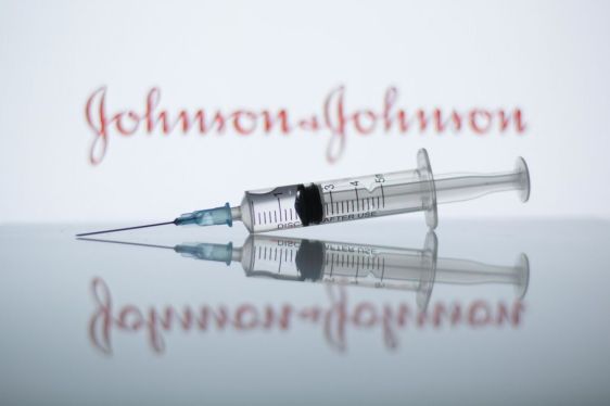 medical syringe with Johnson & Johnson logo in background