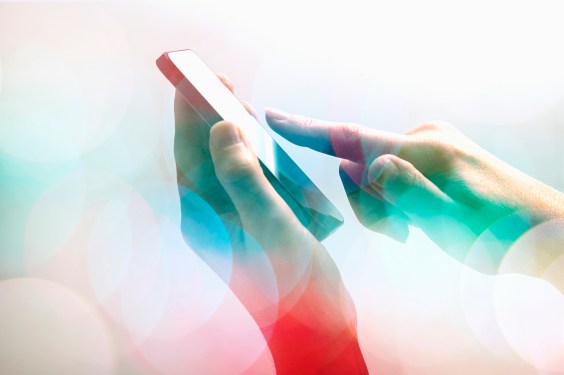 Close-up of female hands with touchscreen.
