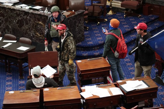 WASHINGTON, DC - JANUARY 06: Protesters enter the Senate Chamber on January 06, 2021 in Washington, DC. Congress held a joint session today to ratify President-elect Joe Biden's 306-232 Electoral College win over President Donald Trump. Pro-Trump protesters have entered the U.S. Capitol building after mass demonstrations in the nation's capital. (Photo by Win McNamee/Getty Images)