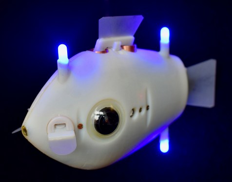 A Bluebot fish-shaped robot with LEDs alight.