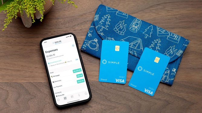 simple app on phone next to two cards