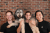 Accord founding team holding their large dog in front of a brick wall background.