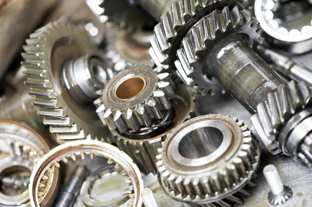 Close-up of automobile engine steel gears and bearings disassembled for repair at car service station