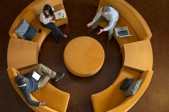 High angle view of business people talking on circular sofa