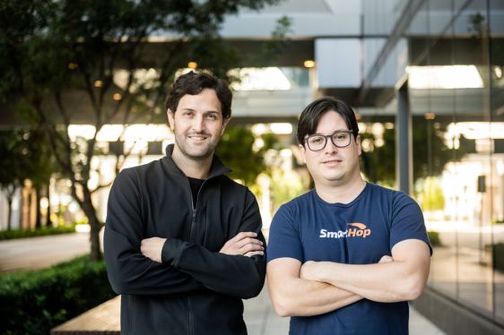 Two people standing next to one another, arms crossed. Company founders