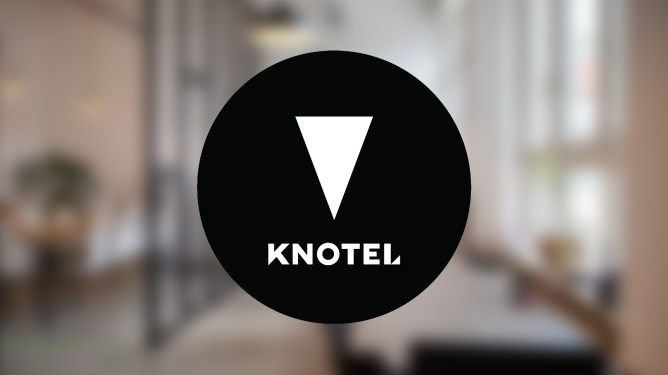 Knotel logo over coworking interior