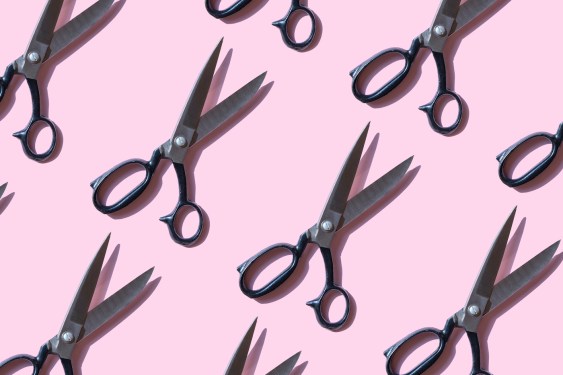 Repeated vintage scissors on pink background