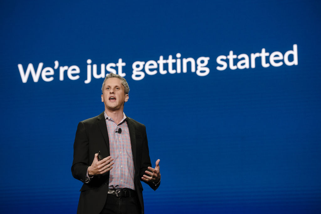 Box's Aaron Levie in front of blue background with words: "We're just getting started."