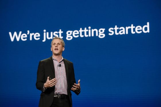 Box's Aaron Levie in front of blue background with words: "We're just getting started."