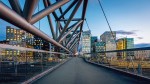 Beautiful twilight over downtown Oslo, the capital city of Norway at Pedestrian Bridge over rails of central railway station. Illuminated modern buildings and skyscapers. Cityscape from elevated walkway in late summer. Oslo, Norway, Scandinavia