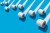 Elevated view of many toilet rolls on blue background