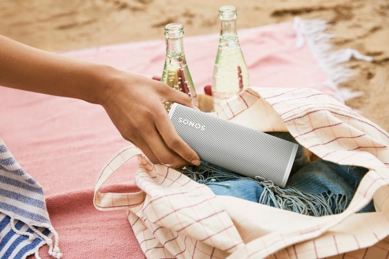 Sonos speaker in a handbag on a beach blanket