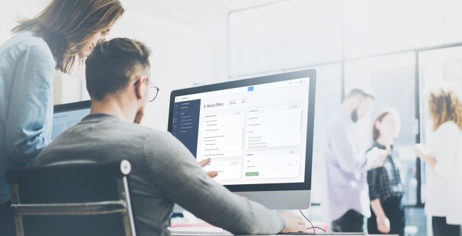 A photo of a man on a computer using UpCodes' building code calculator