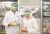 Two technicians in a lab holding Planted brand meat alternative packages.