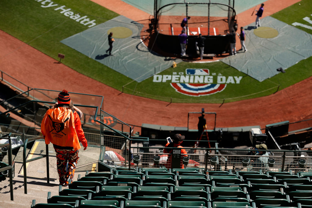 SAN FRANCISCO, CALIFORNIA - APRIL 09: A San Francisco Giants fan watches batting practice before the Giants home opener against the Colorado Rockies at Oracle Park on April 09, 2021 in San Francisco, California. (Photo by Ezra Shaw/Getty Images)