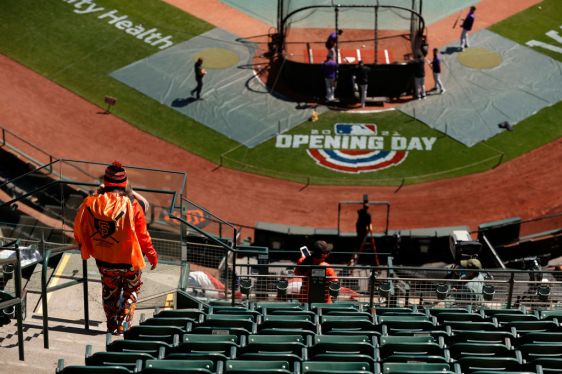SAN FRANCISCO, CALIFORNIA - APRIL 09: A San Francisco Giants fan watches batting practice before the Giants home opener against the Colorado Rockies at Oracle Park on April 09, 2021 in San Francisco, California. (Photo by Ezra Shaw/Getty Images)
