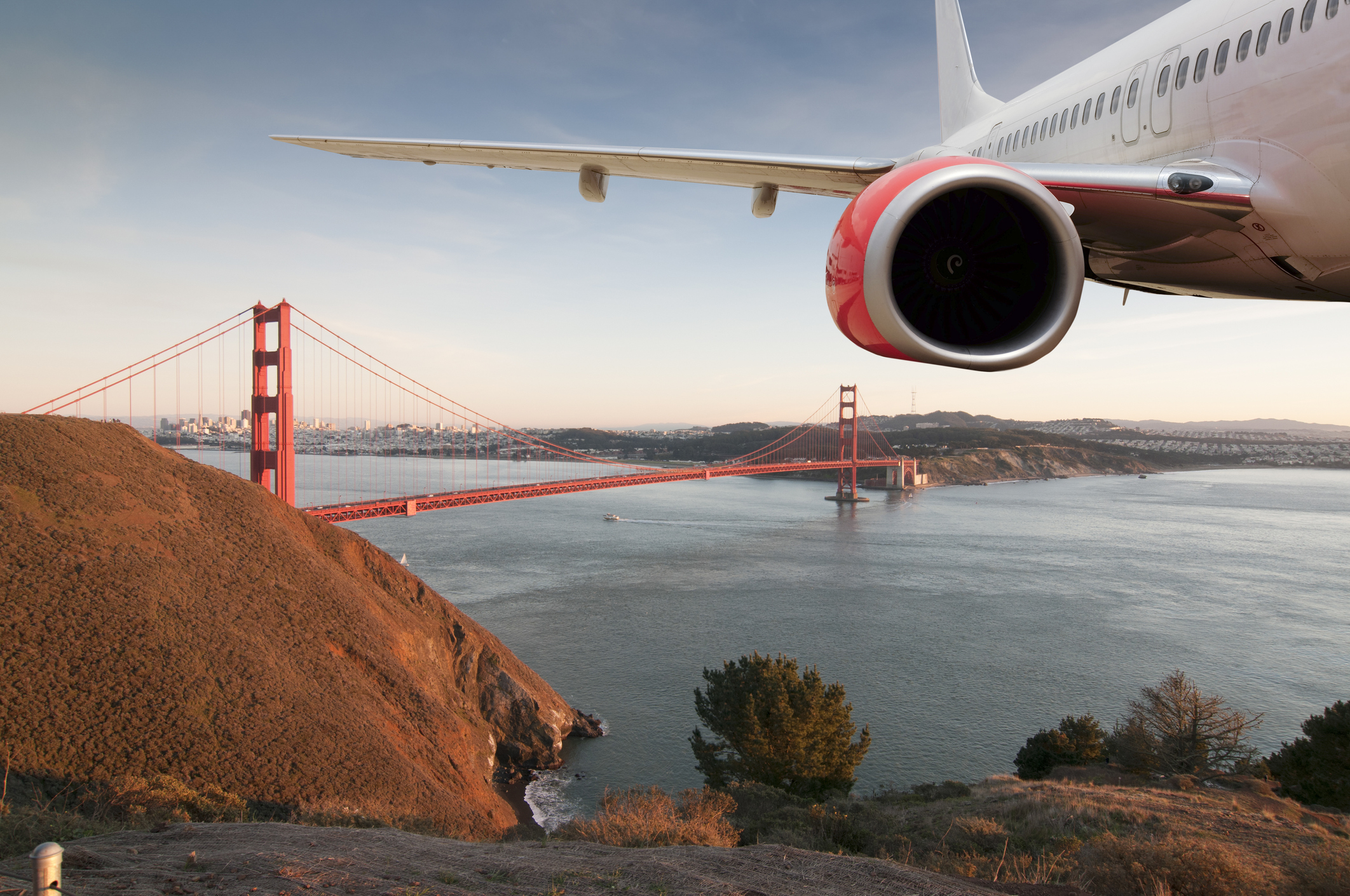 Passenger Jet Plane Flying Above San Francisco for travel concept