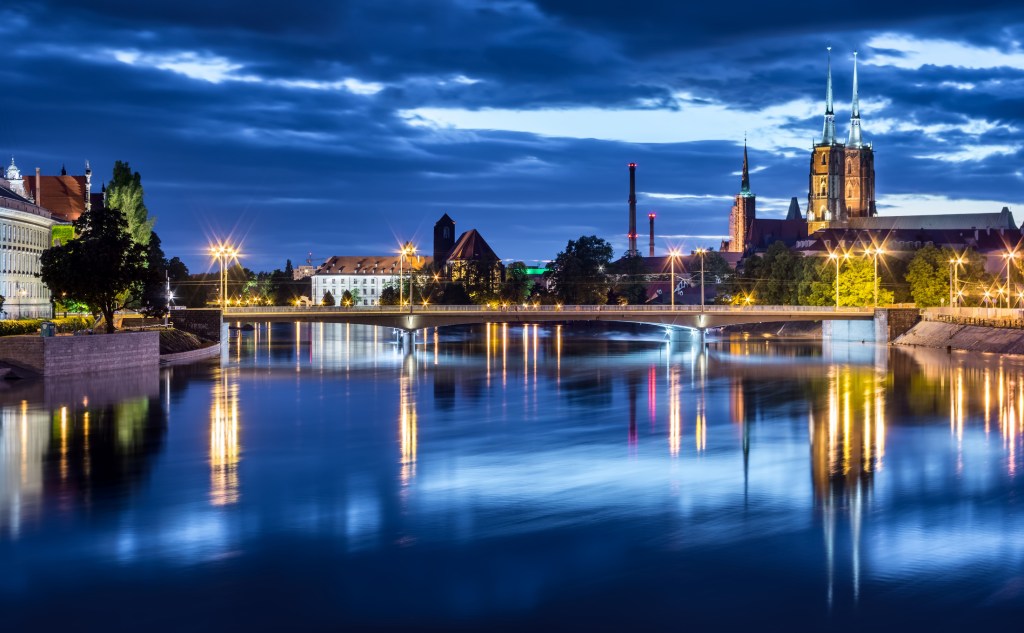 Clouds over illuminated cityscape, Wroclaw, Poland