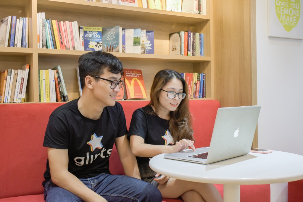 Members of Singapore-based career platform Glints' team working at a laptop