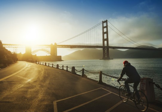 Commuter with road racing bicycle and Golden Gate Bridge