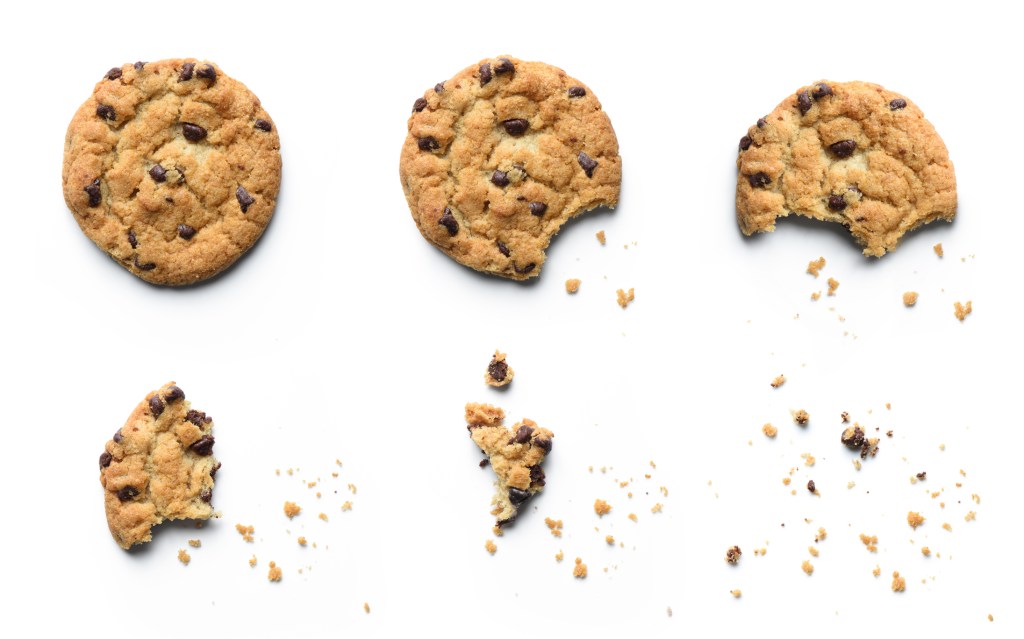 Steps of chocolate chip cookie being devoured. Isolated on white background.
